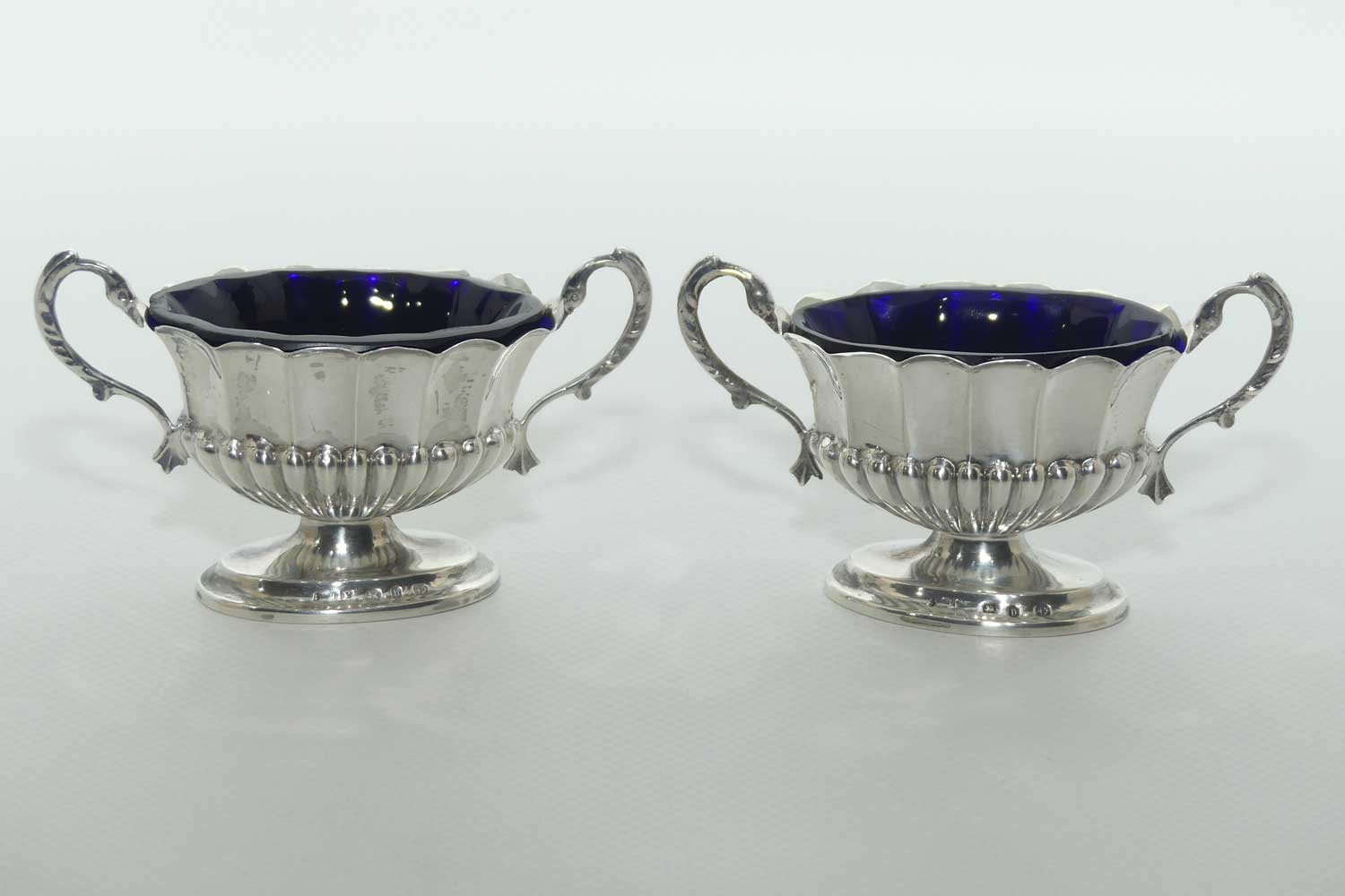 Victorian era Sterling Silver open salts in Campagna vase form with blue glass liners | Birmingham 1876