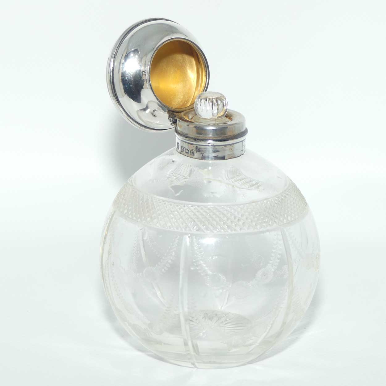 Edwardian era Sterling Silver and cut crystal perfume bottle with fine garlands of flowers decoration