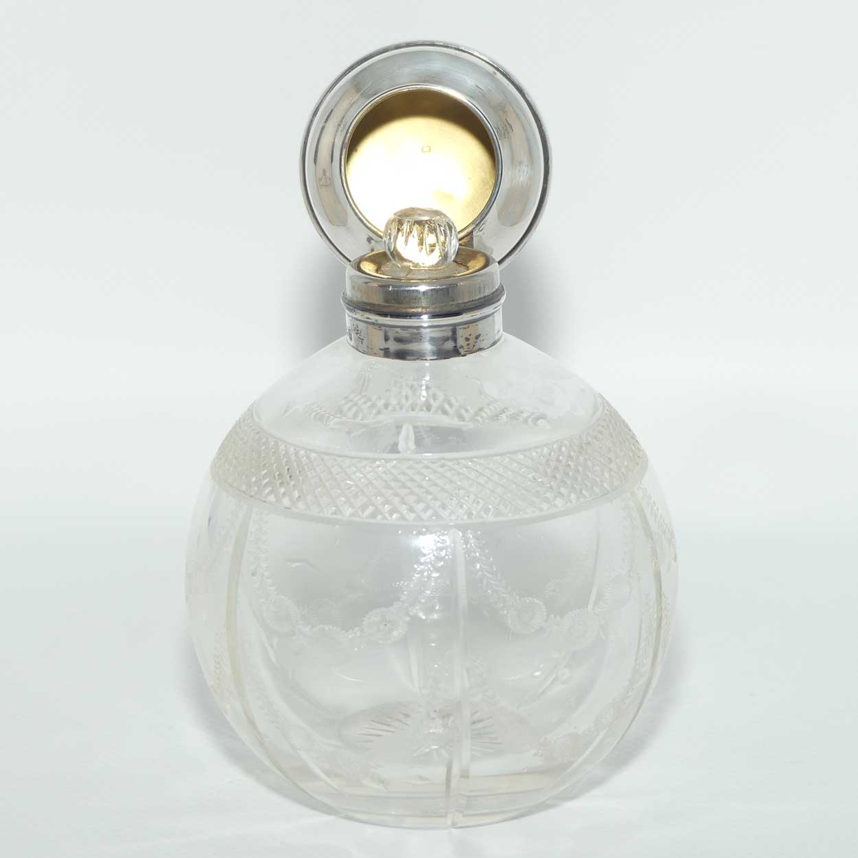 Edwardian era Sterling Silver and cut crystal perfume bottle with fine garlands of flowers decoration