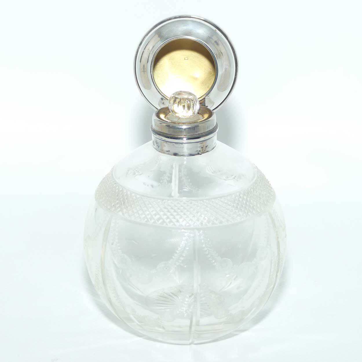 Edwardian era Sterling Silver and cut crystal perfume bottle with fine garlands of flowers decoration