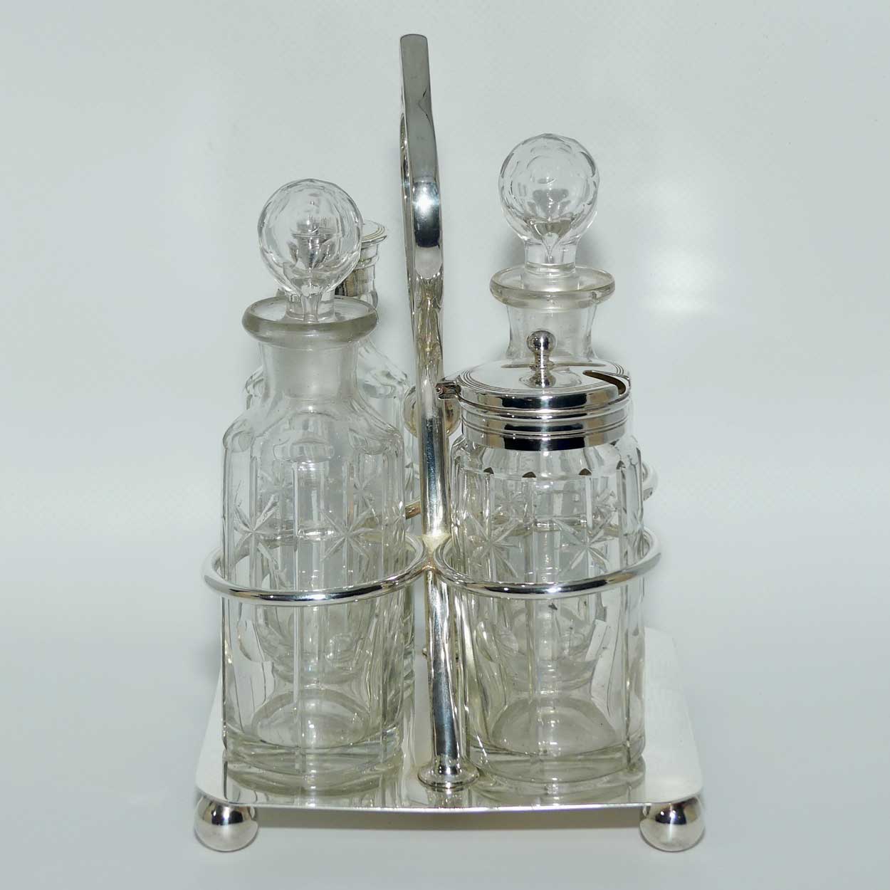 Nice quality Edwardian era 4 bottle cruet set on Silverplated stand | Finely cut bottles