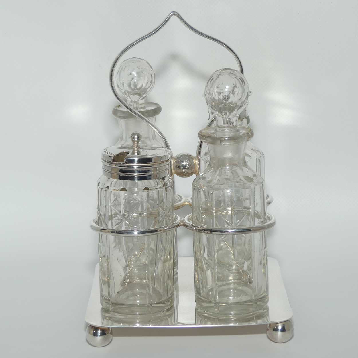 Nice quality Edwardian era 4 bottle cruet set on Silverplated stand | Finely cut bottles