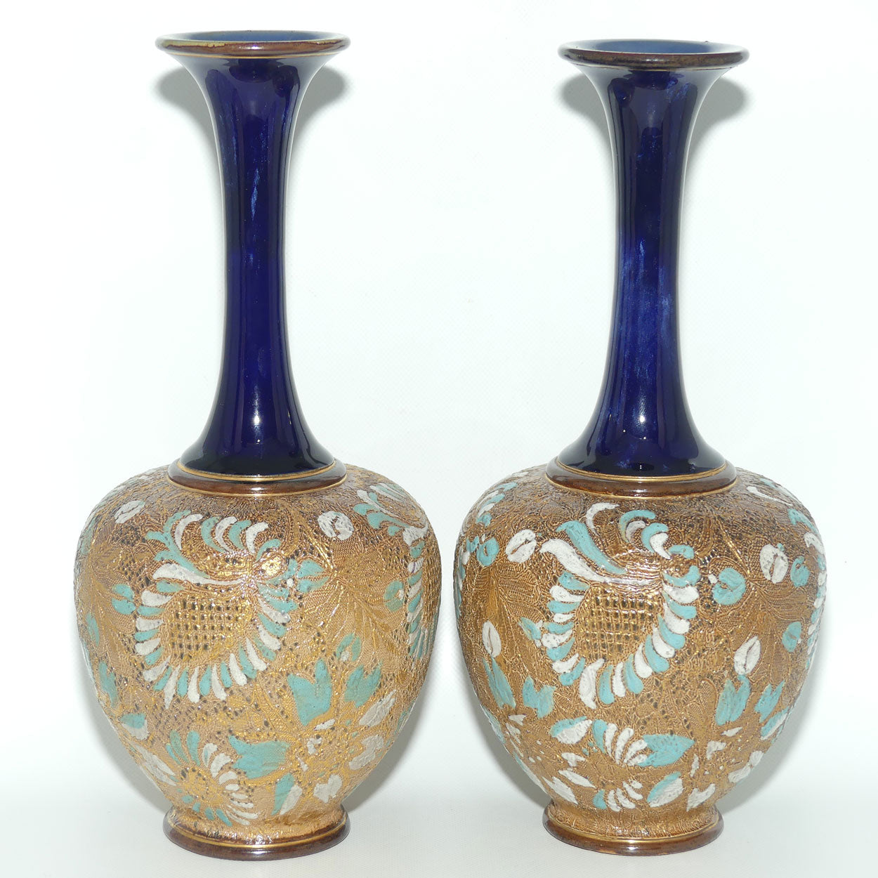 Doulton Slaters Pr of stoneware narrow neck vases with blue & white enamelling & gilt highlights (stamped 5098, painted X5094)