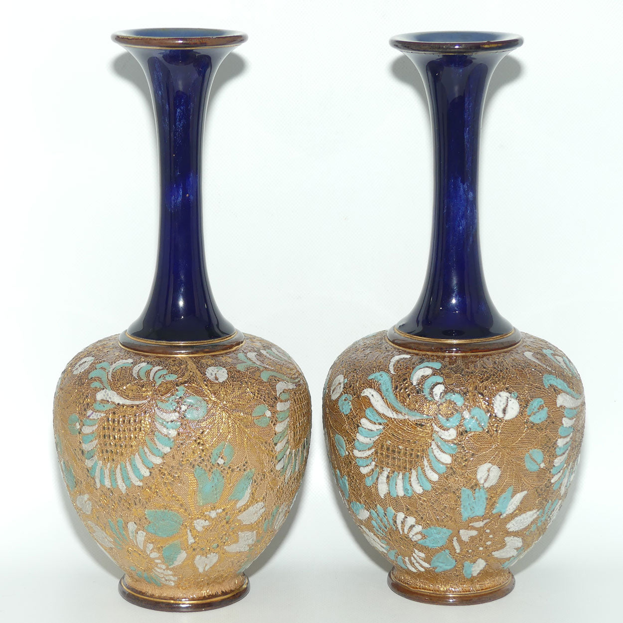 Doulton Slaters Pr of stoneware narrow neck vases with blue & white enamelling & gilt highlights (stamped 5098, painted X5094)