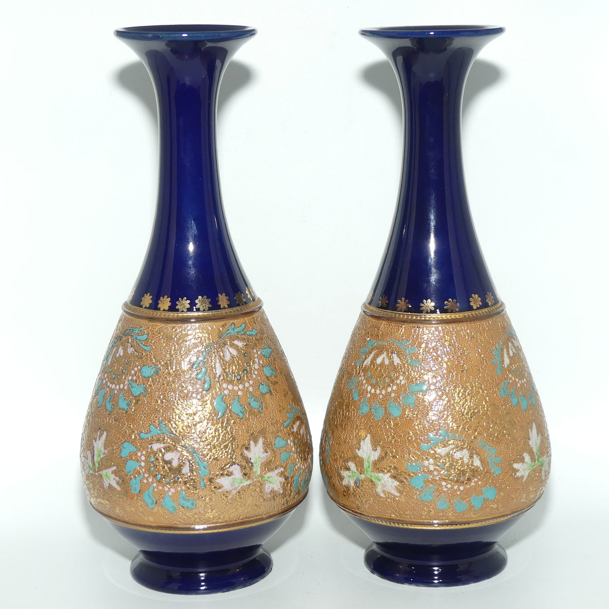 Doulton Slaters stoneware pair of narrowneck bulbous vases with blue, white & green enamelling and gilt highlights (stamped 672)