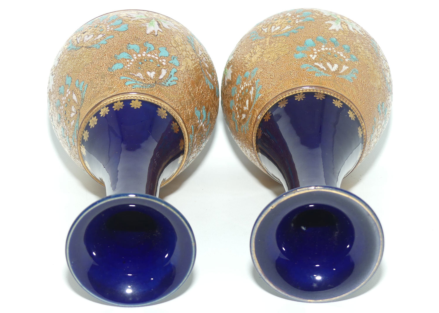 Doulton Slaters stoneware pair of narrowneck bulbous vases with blue, white & green enamelling and gilt highlights (stamped 672)