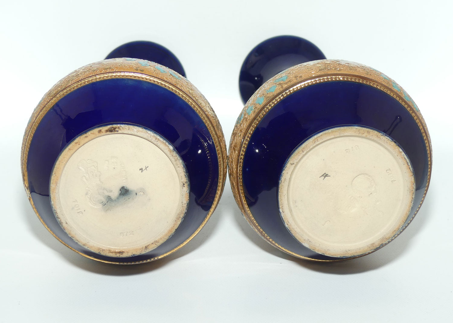 Doulton Slaters stoneware pair of narrowneck bulbous vases with blue, white & green enamelling and gilt highlights (stamped 672)