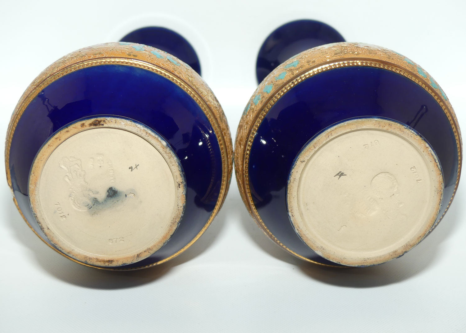 Doulton Slaters stoneware pair of narrowneck bulbous vases with blue, white & green enamelling and gilt highlights (stamped 672)