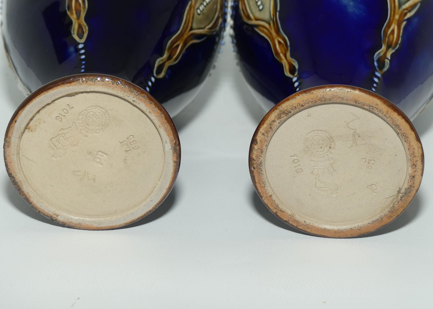 Royal Doulton pair of stoneware ewers with applied flowers, hearts and dots (stamped 7018)