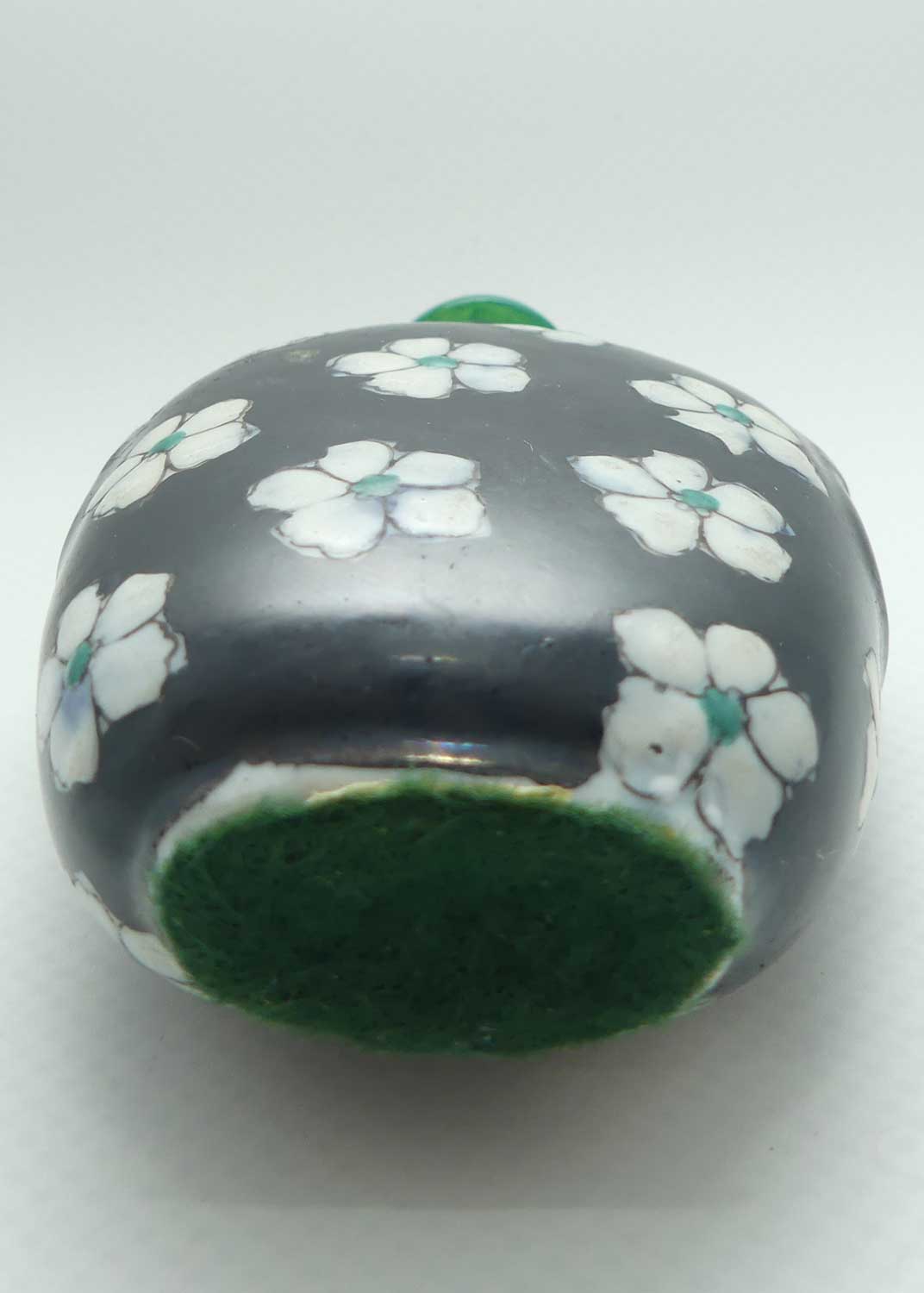 Chinese Black Ground and White Floral pattern Snuff Bottle | Green stone stopper
