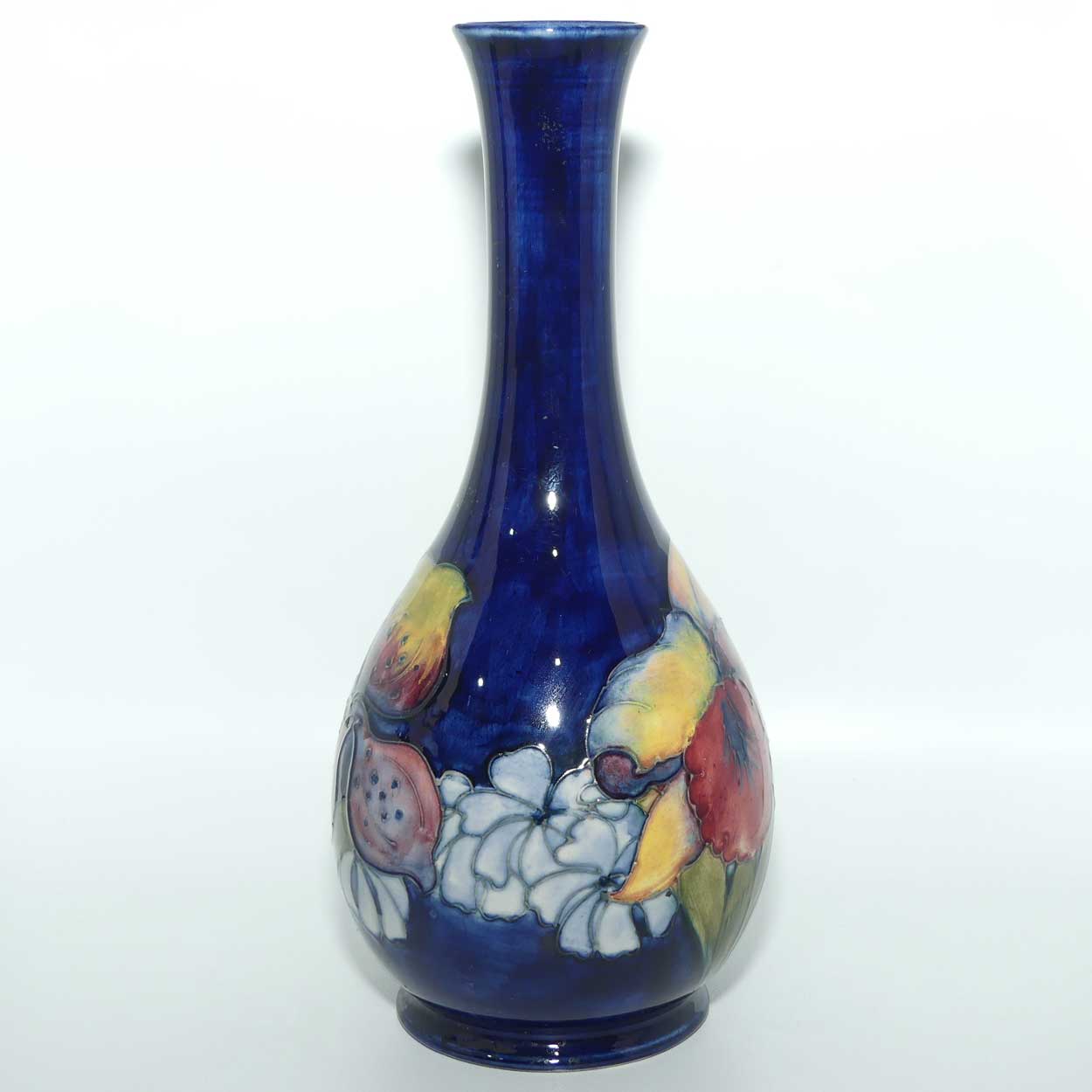Walter Moorcroft Orchid on Dark Blue Ground tall narrow neck bottle vase