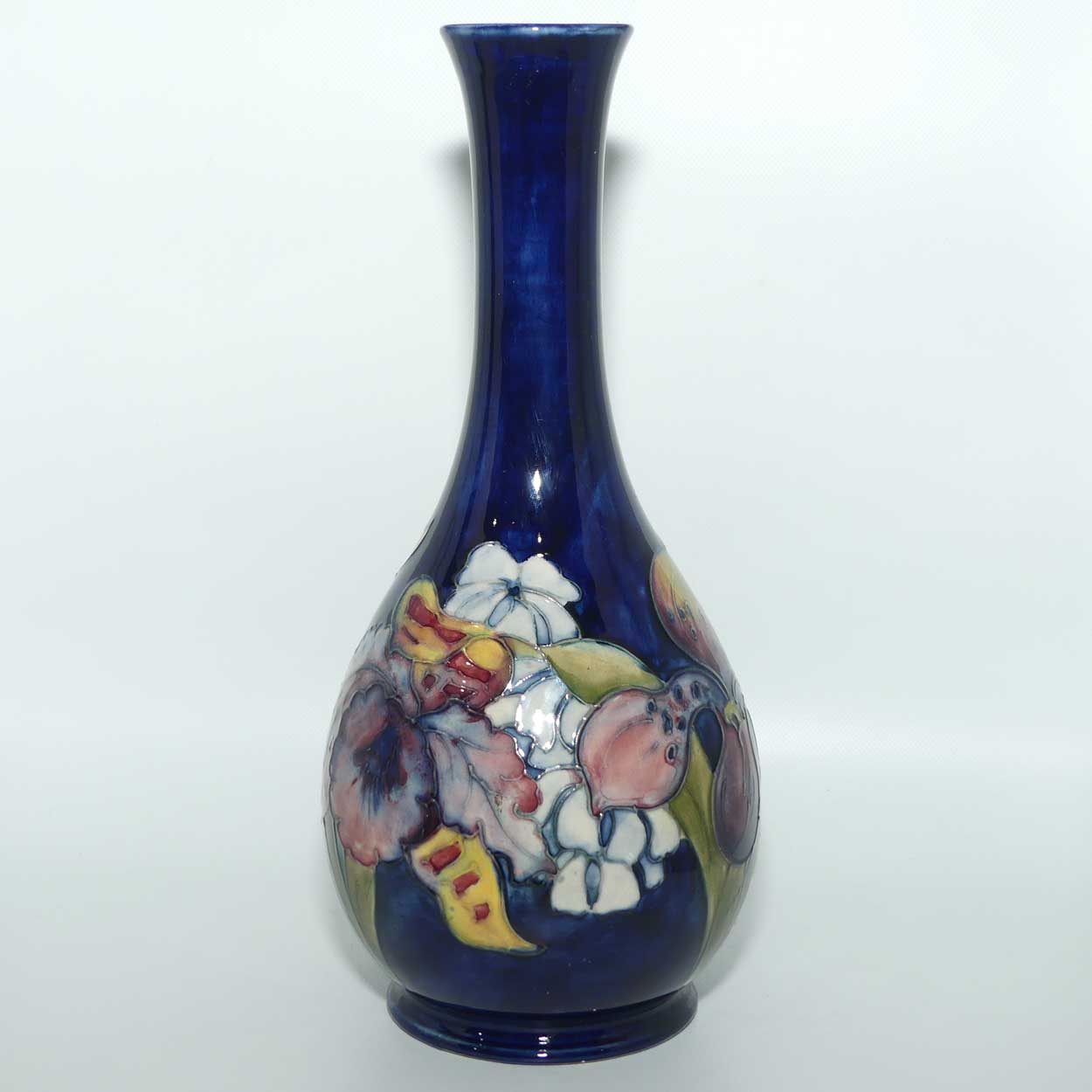 Walter Moorcroft Orchid on Dark Blue Ground tall narrow neck bottle vase