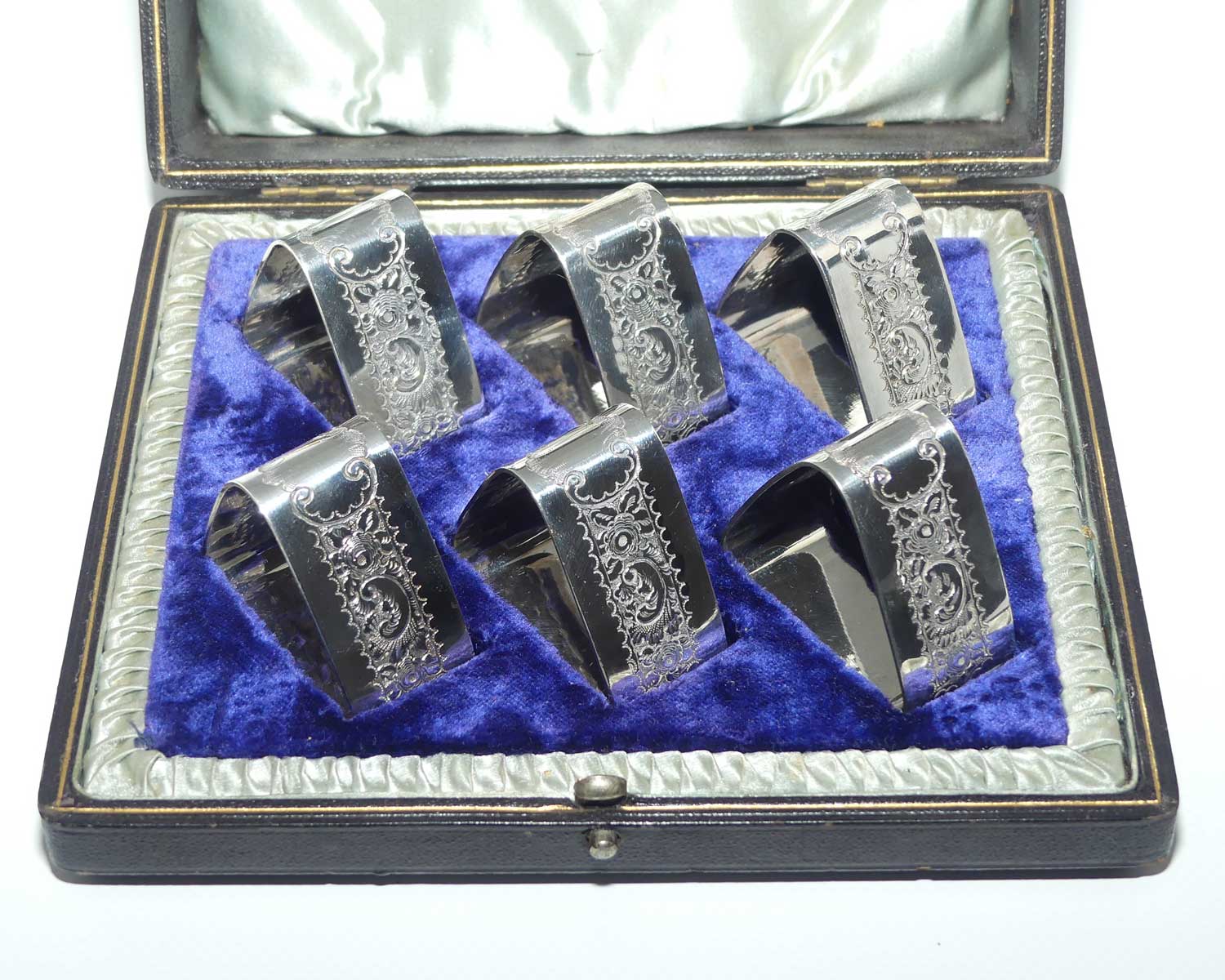 Edwardian era set of 6 Embossed triangular Silver plated napkin rings