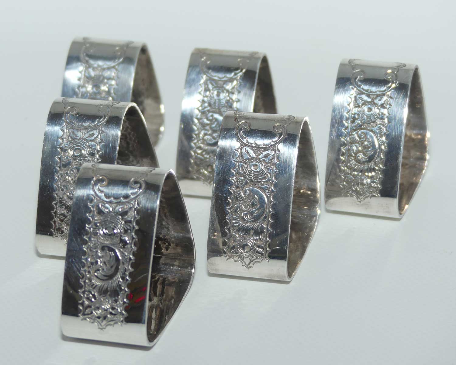 Edwardian era set of 6 Embossed triangular Silver plated napkin rings