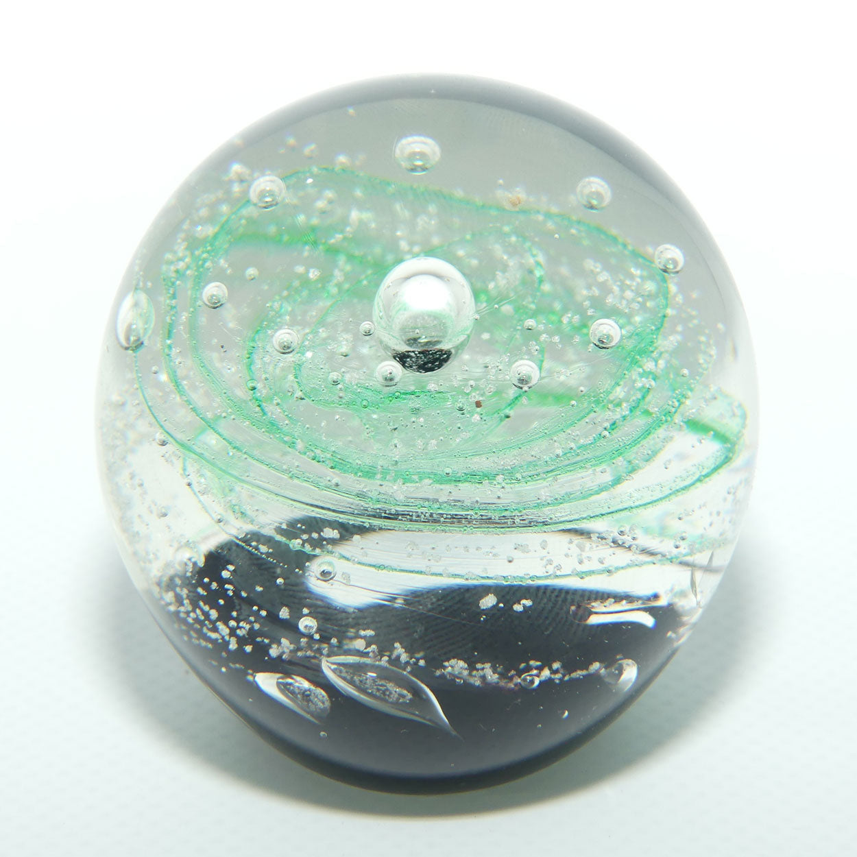Controlled bubble within Green Swirl paperweight