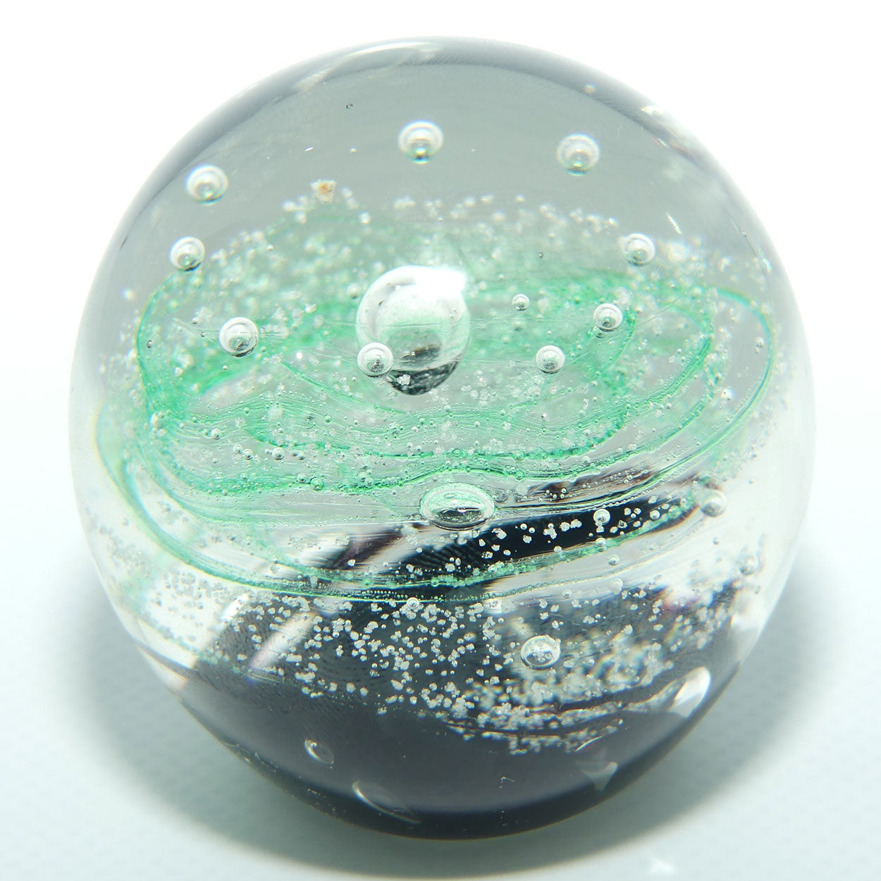 Controlled bubble within Green Swirl paperweight
