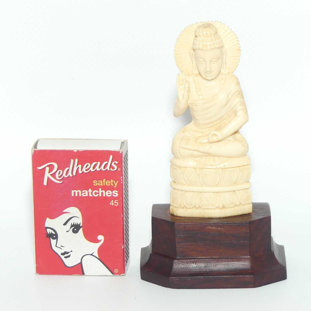 Finely carved Carved Ivory Buddha on Rosewood stand