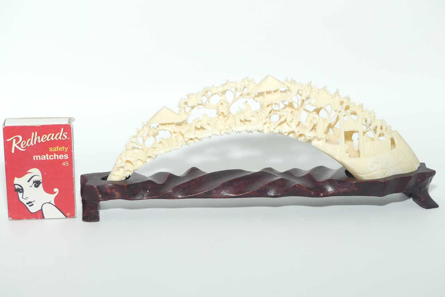 Carved Ivory Tusk depicting Chinese Village on wooden stand | 20cm