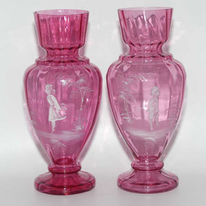 Cranberry Mary Gregory pair of vases depicting a boy with a walking cane and a girl on tip toes