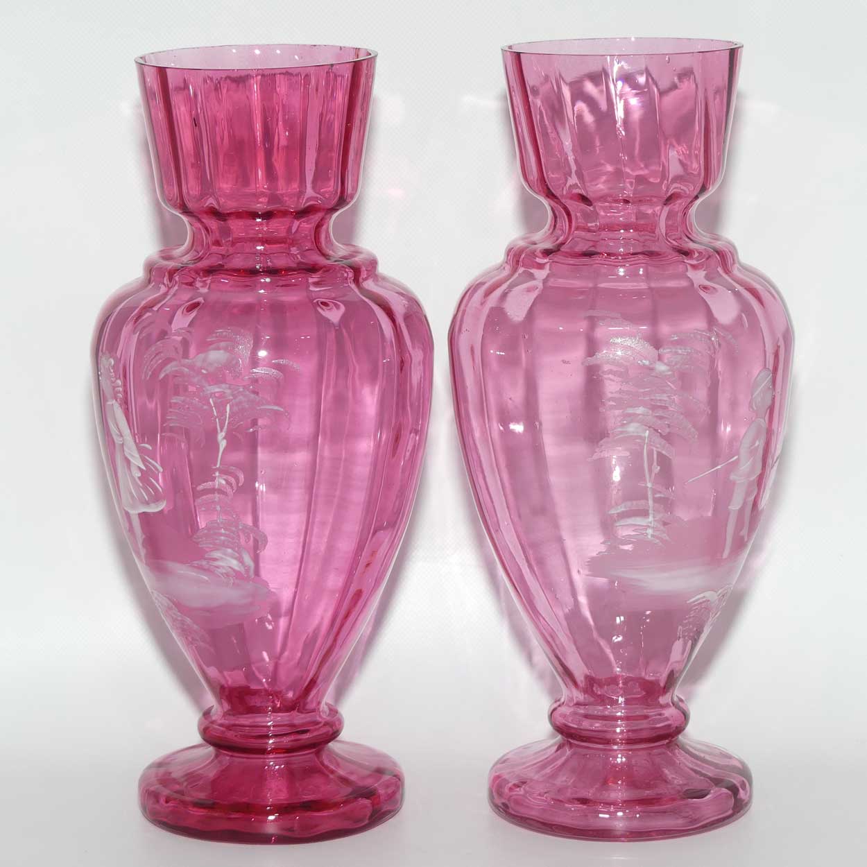 Cranberry Mary Gregory pair of vases depicting a boy with a walking cane and a girl on tip toes