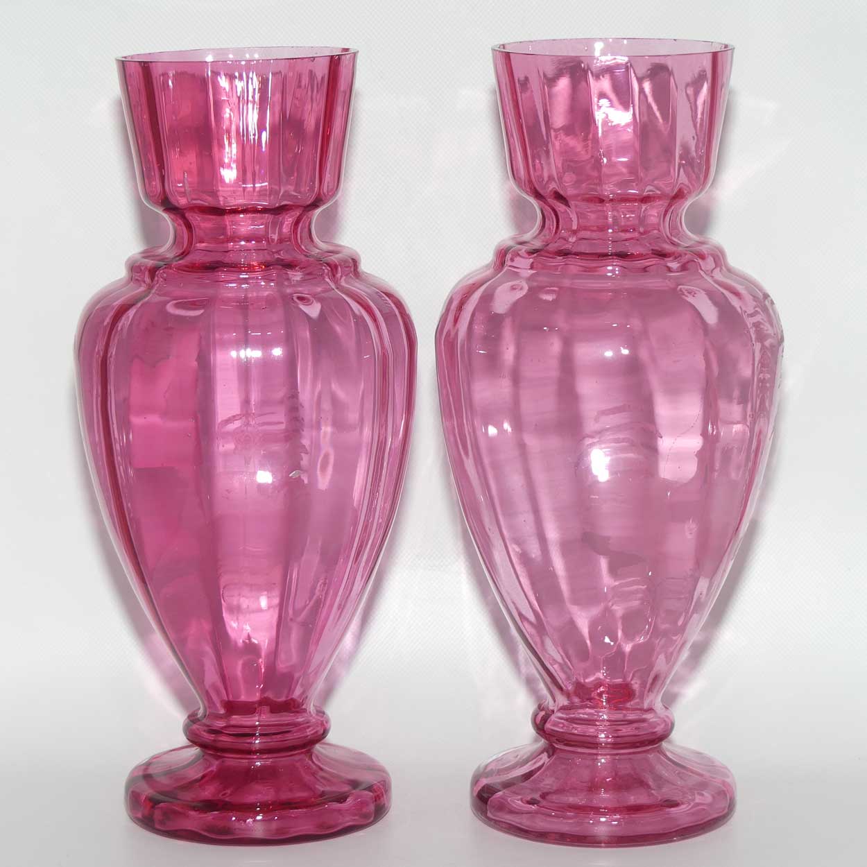 Cranberry Mary Gregory pair of vases depicting a boy with a walking cane and a girl on tip toes