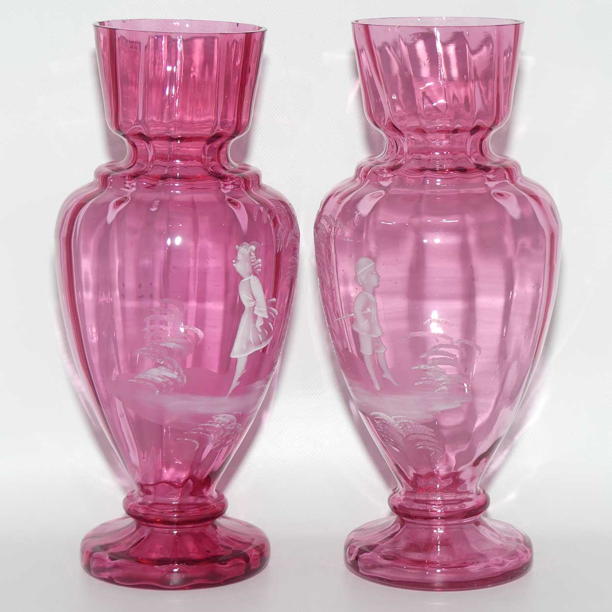 Cranberry Mary Gregory pair of vases depicting a boy with a walking cane and a girl on tip toes