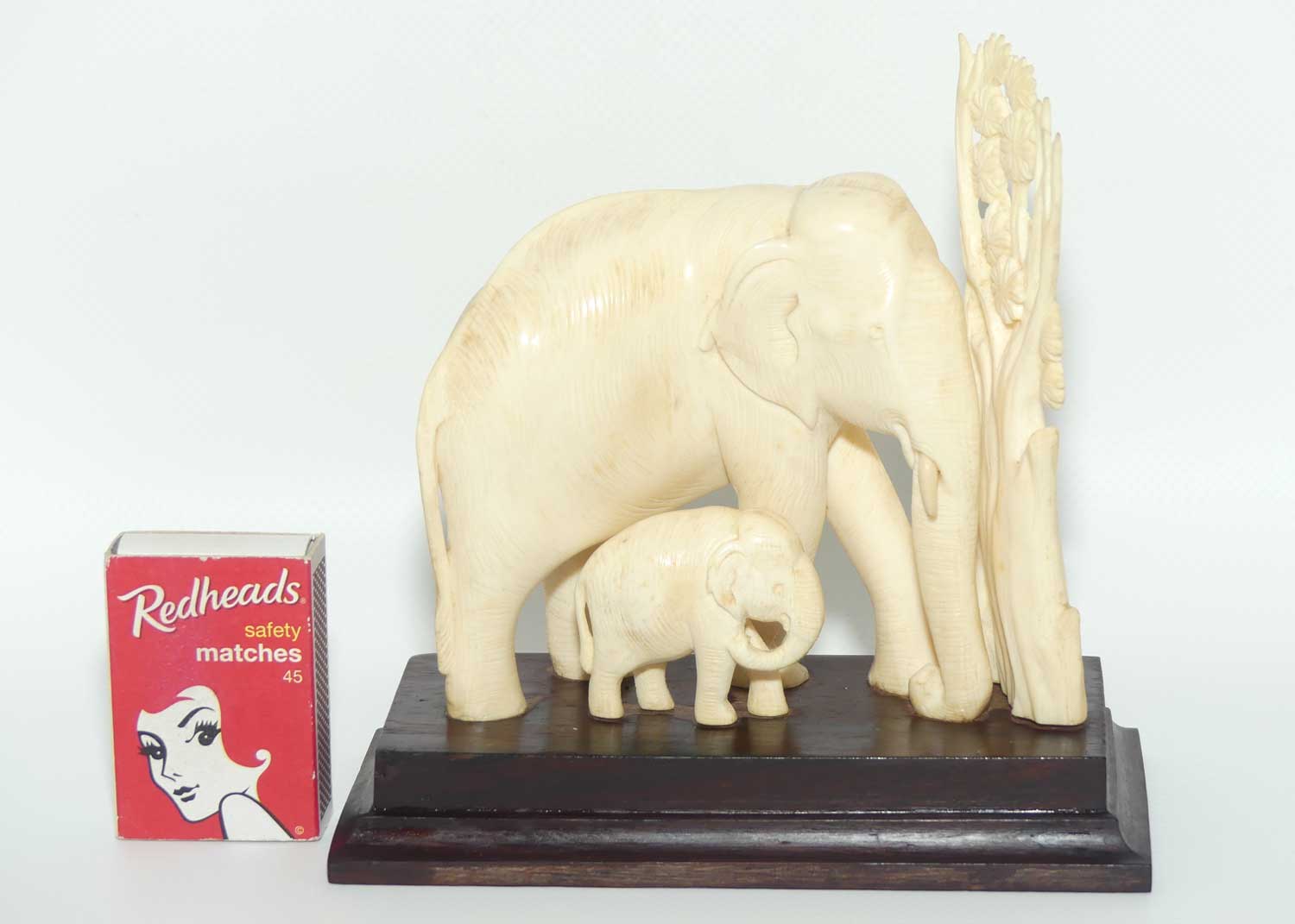 Carved Ivory figure of Mother Elephant and Calf on Rosewood Base