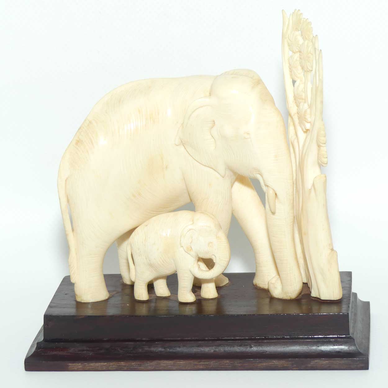 Carved Ivory figure of Mother Elephant and Calf on Rosewood Base