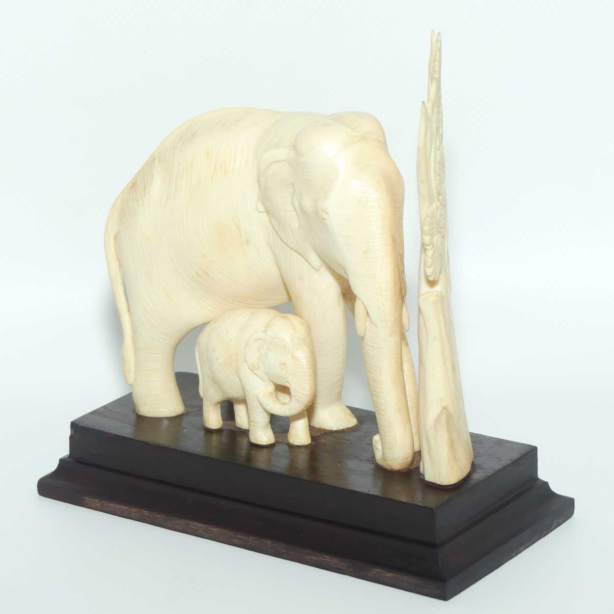 Carved Ivory figure of Mother Elephant and Calf on Rosewood Base