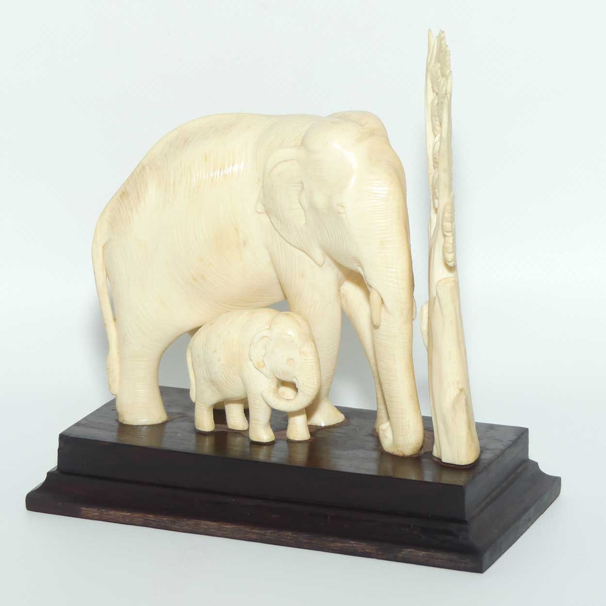 Carved Ivory figure of Mother Elephant and Calf on Rosewood Base