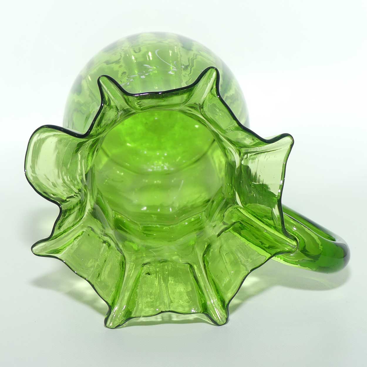 Green Mary Gregory crimped rim glass jug depicting a young girl sitting on bench