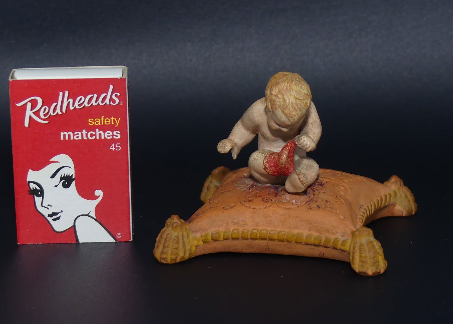 P. Ipsens Eneret terracotta figure of a baby on cushion | 442