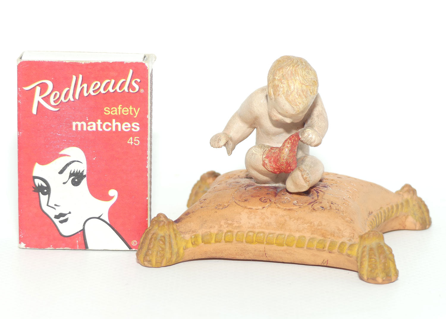 P. Ipsens Eneret terracotta figure of a baby on cushion | 442