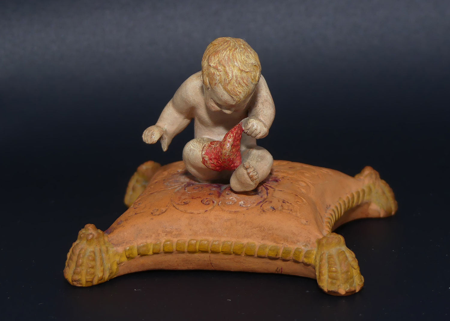 P. Ipsens Eneret terracotta figure of a baby on cushion | 442