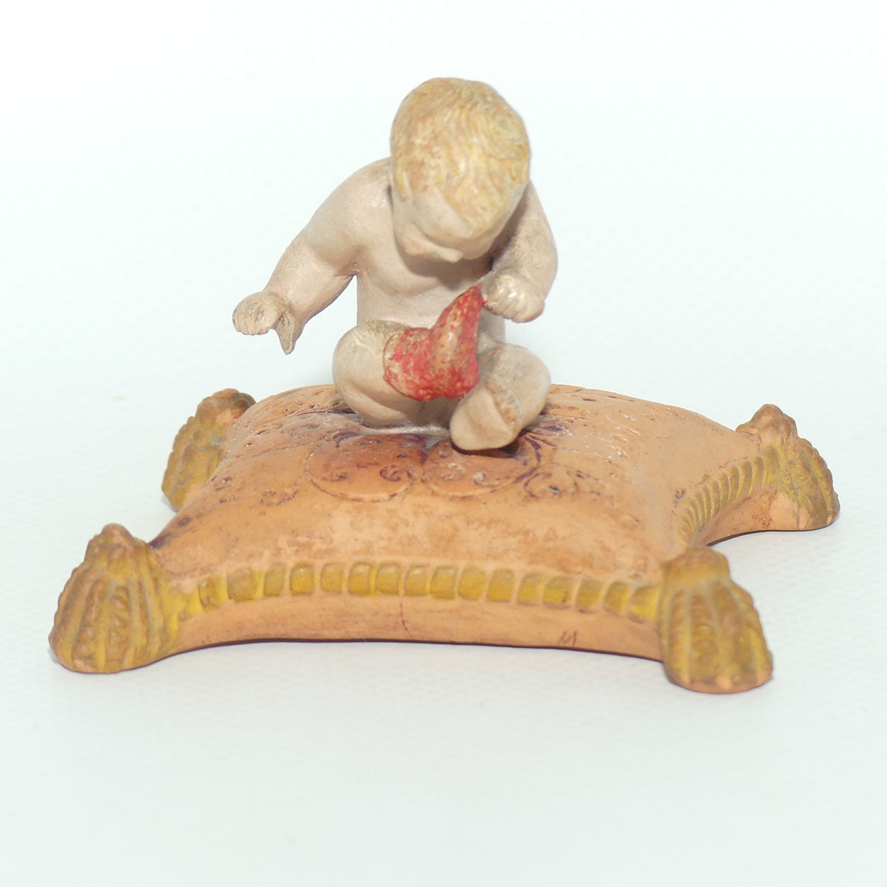 P. Ipsens Eneret terracotta figure of a baby on cushion | 442