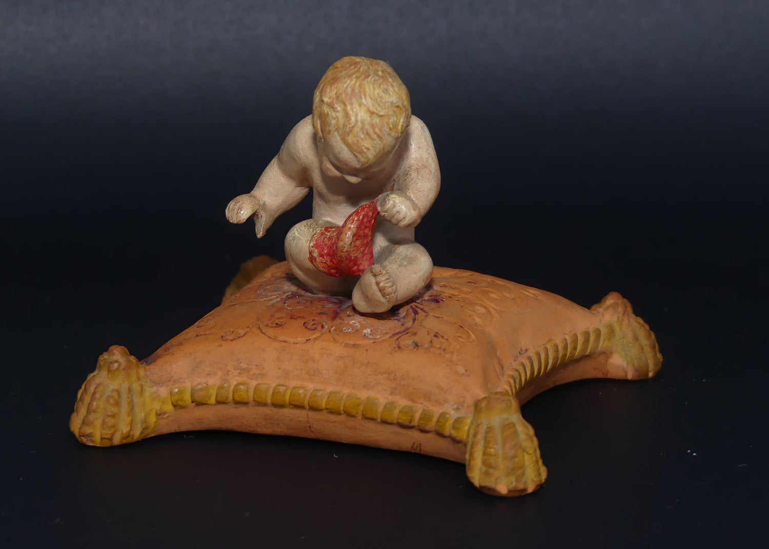 P. Ipsens Eneret terracotta figure of a baby on cushion | 442