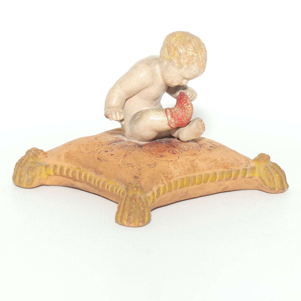 P. Ipsens Eneret terracotta figure of a baby on cushion | 442