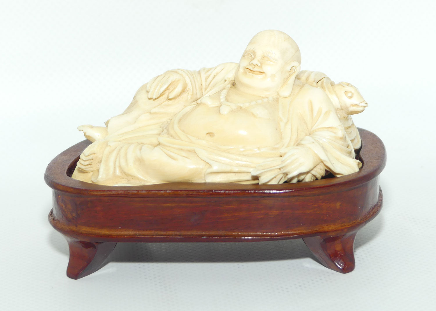 Elaborately carved Ivory Reclining Laughing Buddha on Wooden Stand | signed piece