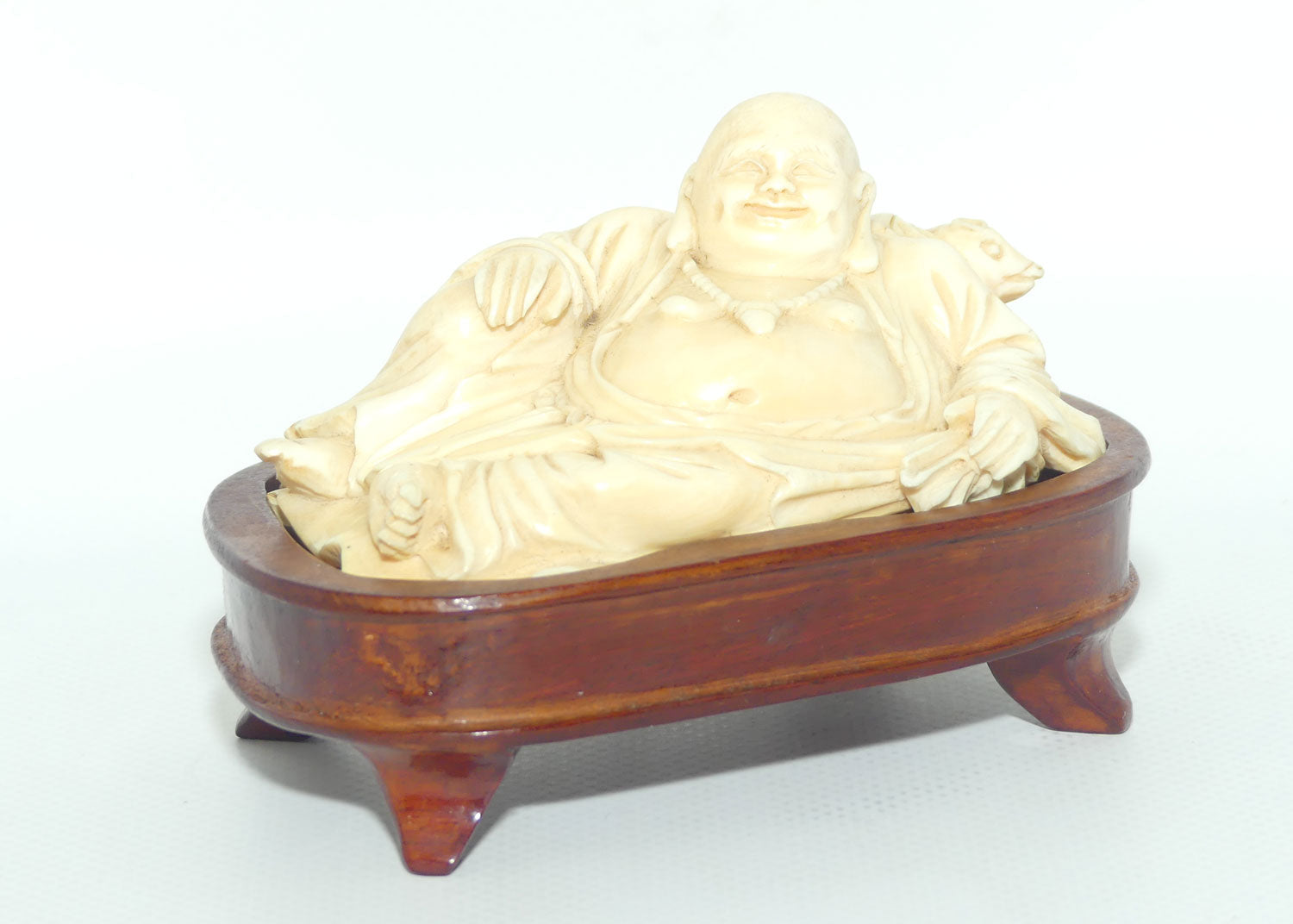 Elaborately carved Ivory Reclining Laughing Buddha on Wooden Stand | signed piece
