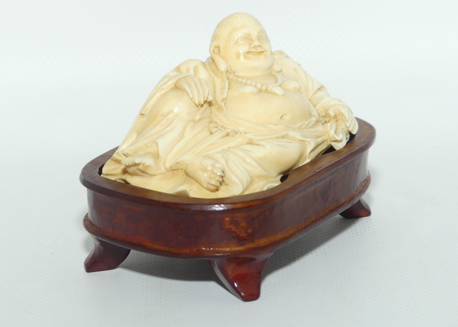 Elaborately carved Ivory Reclining Laughing Buddha on Wooden Stand | signed piece