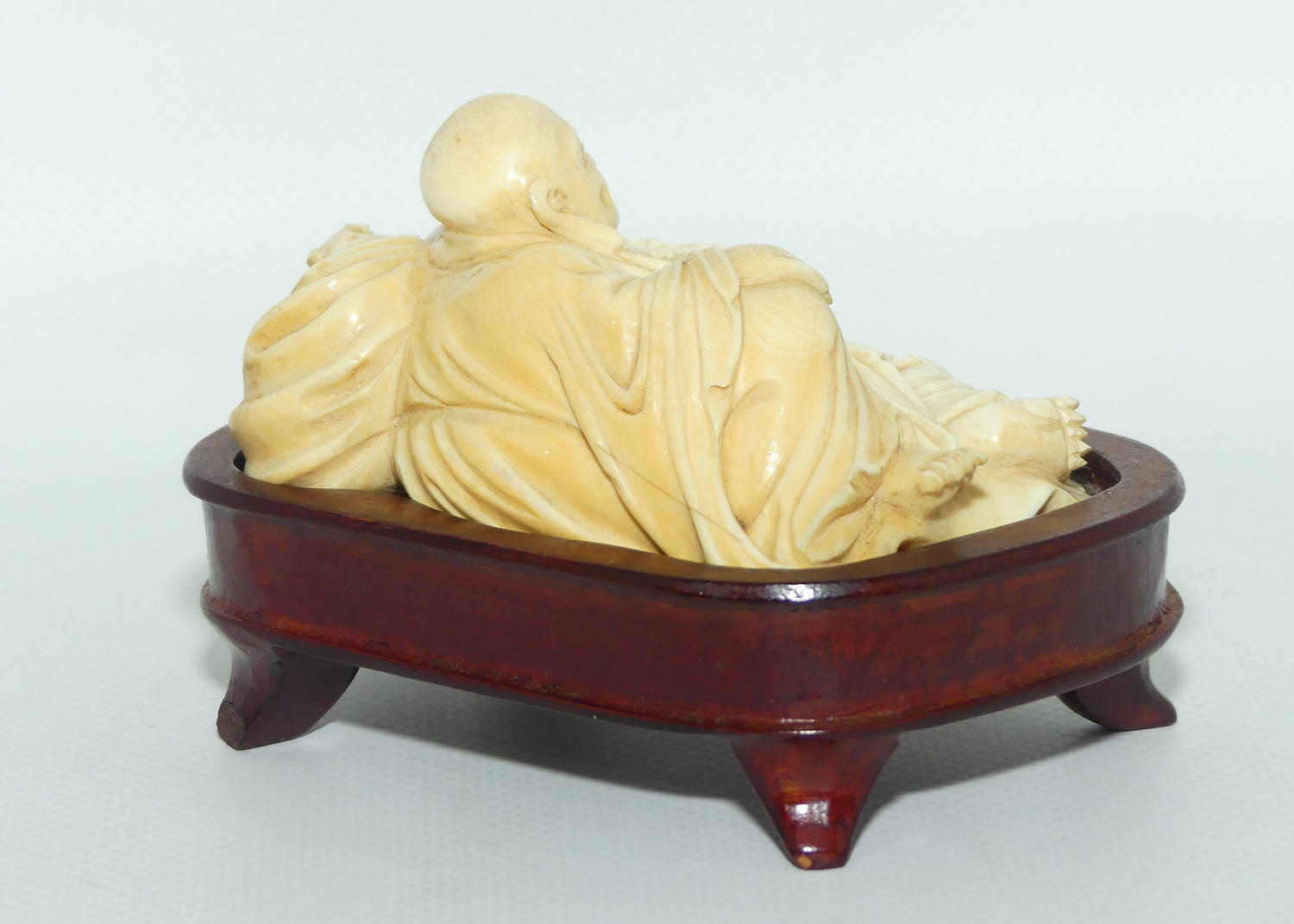 Elaborately carved Ivory Reclining Laughing Buddha on Wooden Stand | signed piece