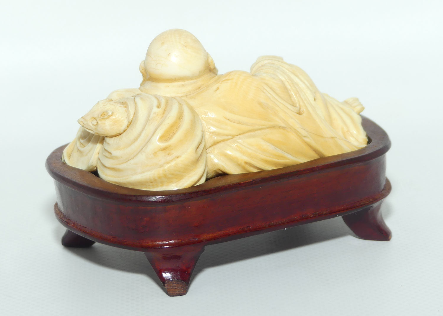 Elaborately carved Ivory Reclining Laughing Buddha on Wooden Stand | signed piece