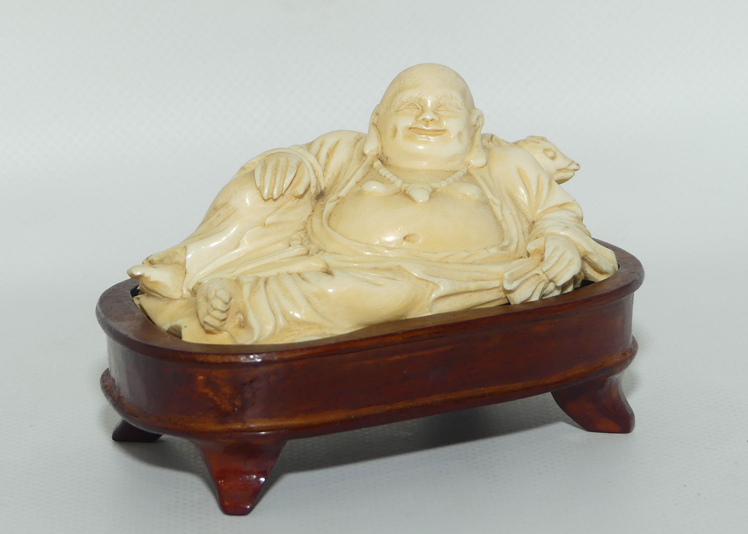 Elaborately carved Ivory Reclining Laughing Buddha on Wooden Stand | signed piece