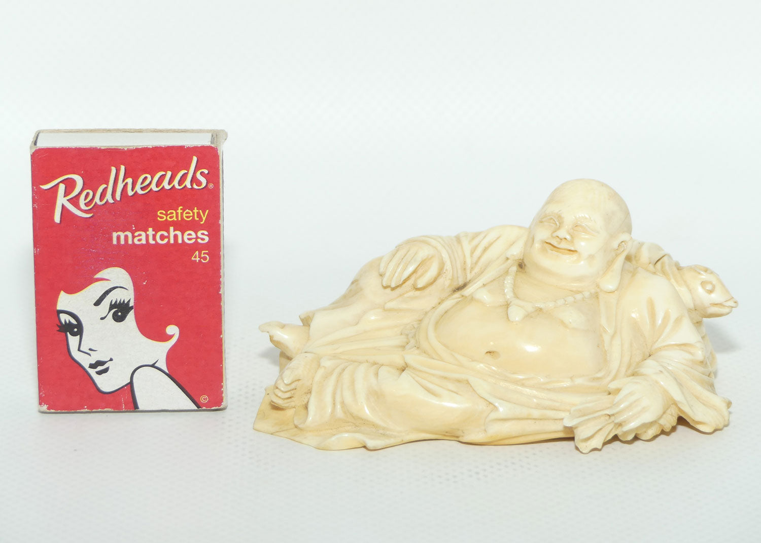 Elaborately carved Ivory Reclining Laughing Buddha on Wooden Stand | signed piece