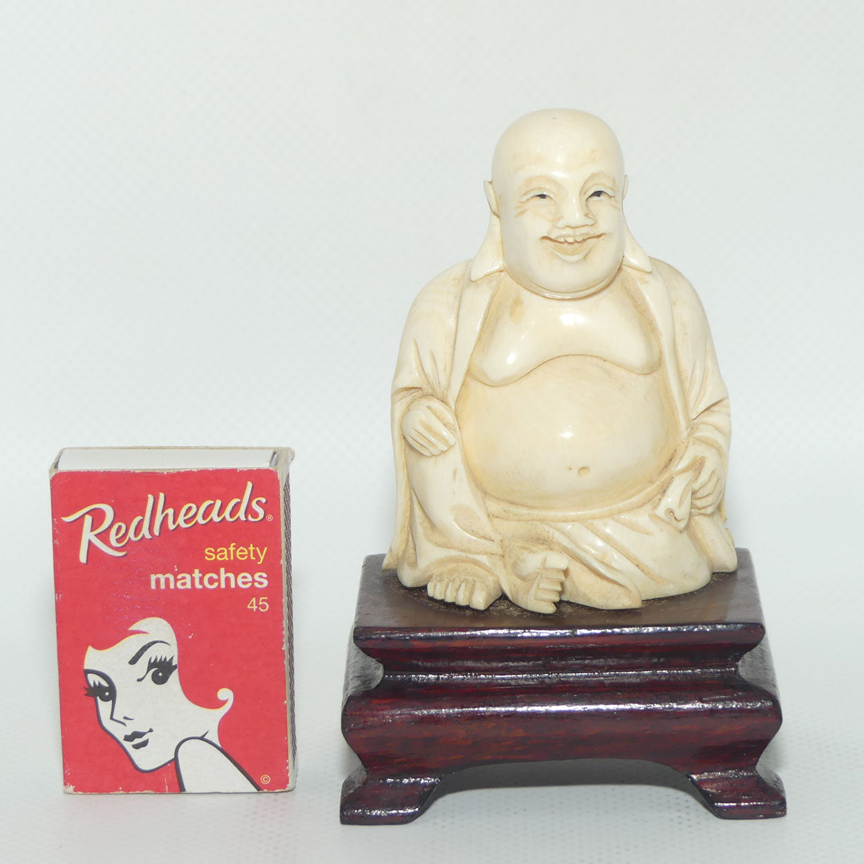 Beautifully carved Ivory Laughing Buddha Seated on Wooden Stand