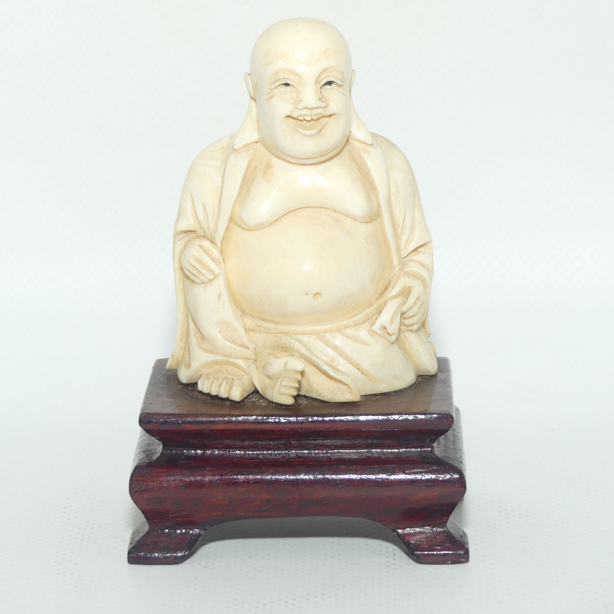 Beautifully carved Ivory Laughing Buddha Seated on Wooden Stand