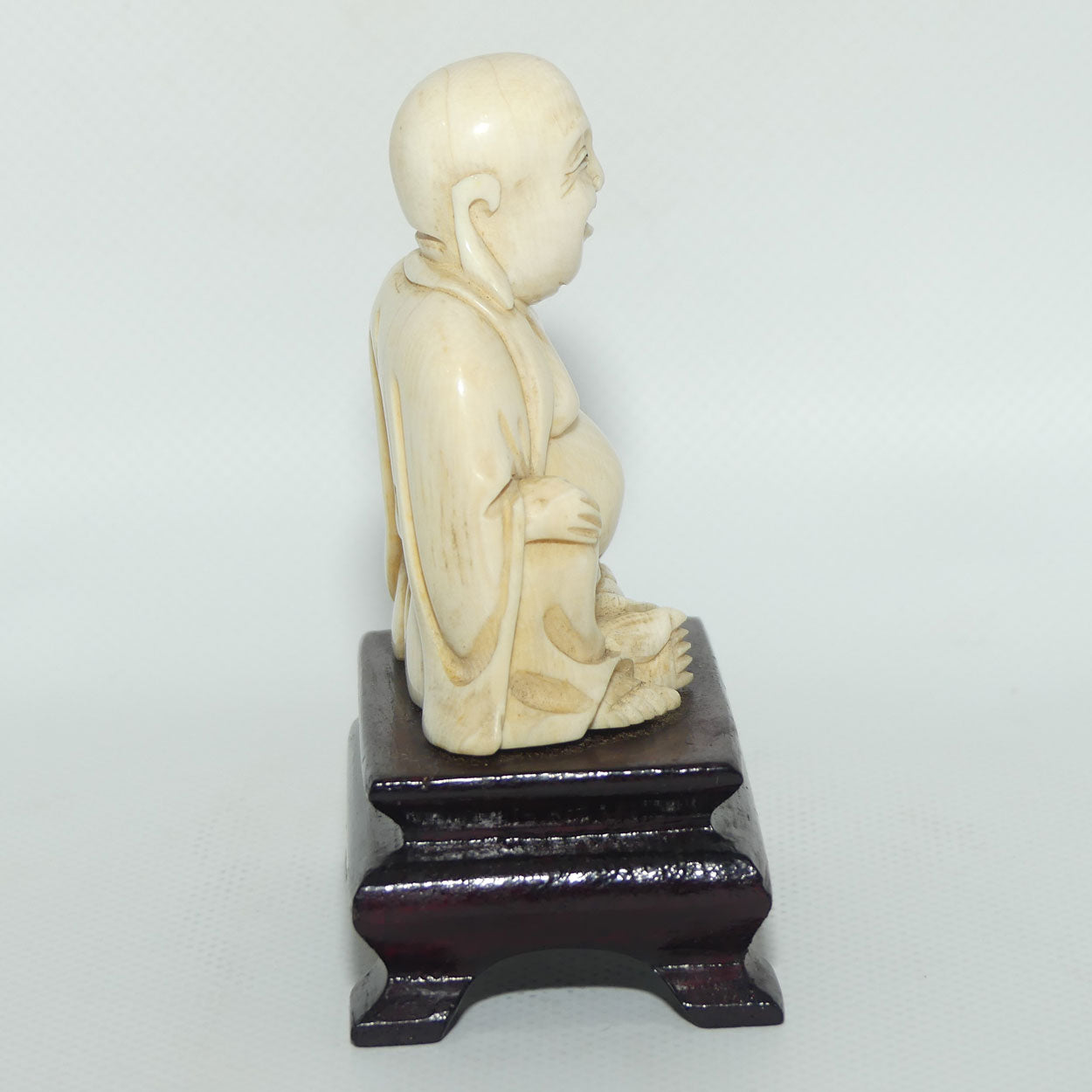 Beautifully carved Ivory Laughing Buddha Seated on Wooden Stand