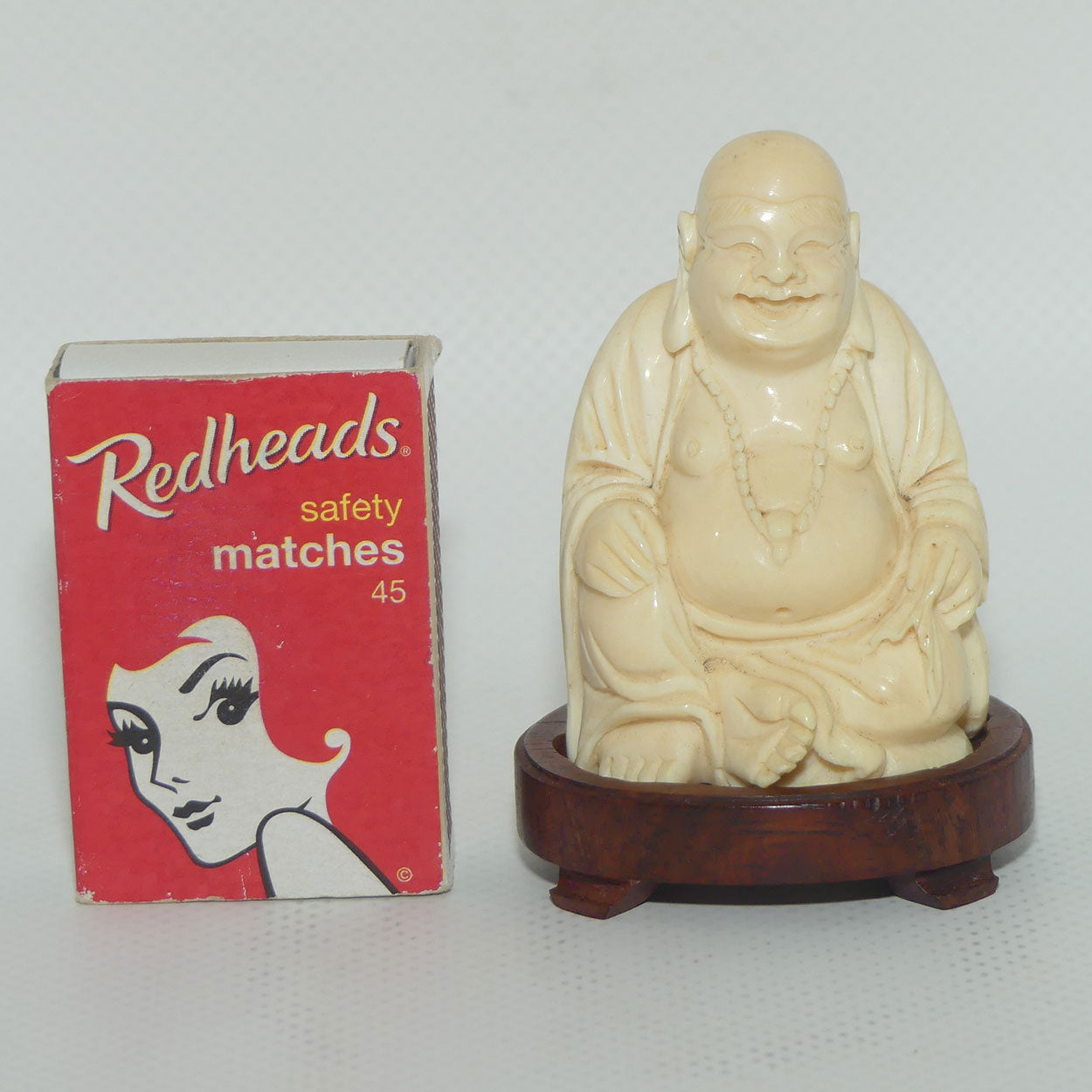 Beautifully carved Ivory Laughing Buddha Seated on Wooden Stand | signed | 7.5cm tall