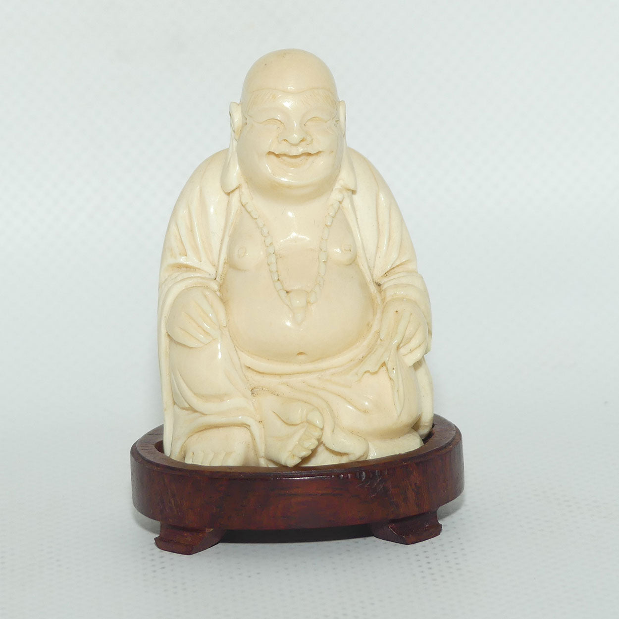 Beautifully carved Ivory Laughing Buddha Seated on Wooden Stand | signed | 7.5cm tall