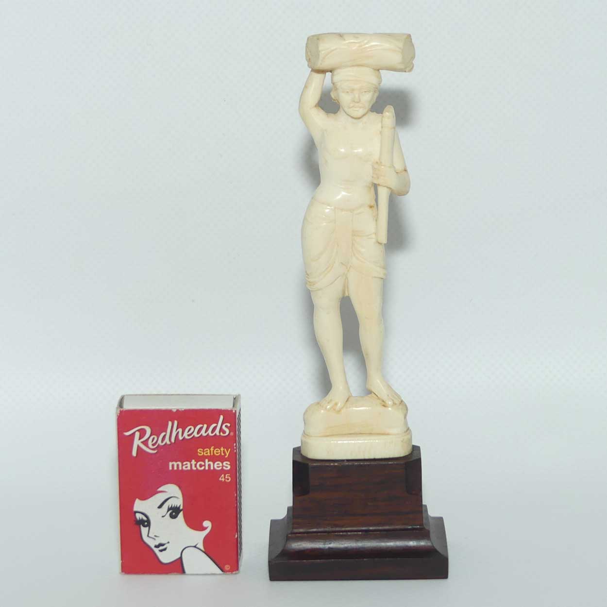 Carved Ivory Figure on Rosewood base | Man with Axe Carrying Log on Head | 17cm
